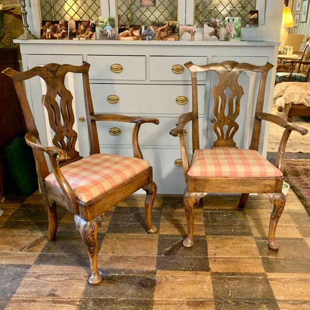 An unusual pair of Continental Rococo carved armchairs that show English influence in the “Chippendale” backs and general...