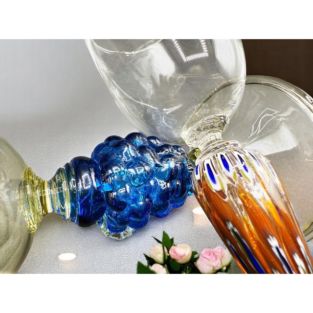 Two enchanting Murano glasses. The taller glass with murrine has a long and slender stem, decorated with colorful motifs...