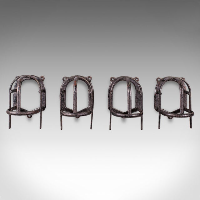 This is a quartet of small antique crop hanging racks. An English, wrought iron equestrian wall mounted coat hook, dating...