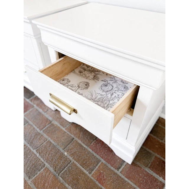 A beautifully refinished pair of vintage two-drawer nightstands with substantial traditional styling and a fresh, updated...