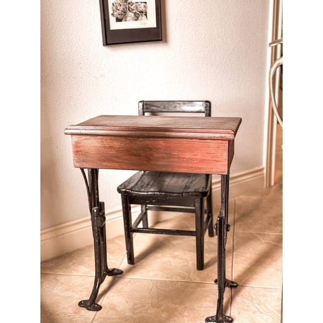 This authentic antique child’s school desk by Chandler features a solid wood writing surface paired with a sturdy cast...