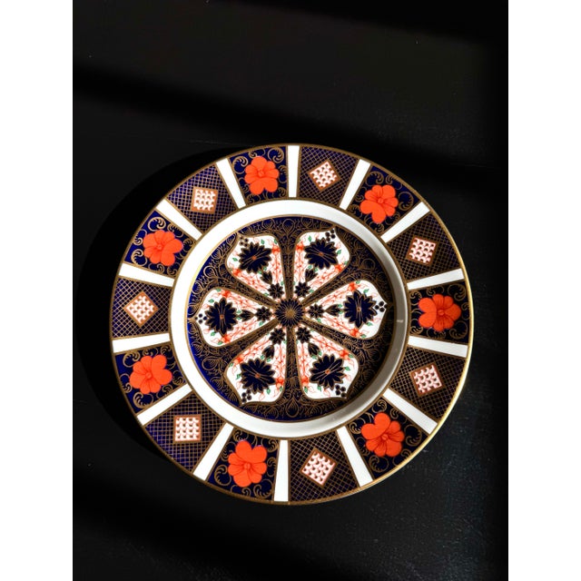 An elegant Royal Crown Derby Old Imari salad plate in the celebrated Pattern 1128, renowned for its richly detailed cobalt...