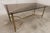1960s coffee table in gilt brass and smoked glass. Tabletop dimensions: 90 x 45 cm height: 39.5 cm It is in good...