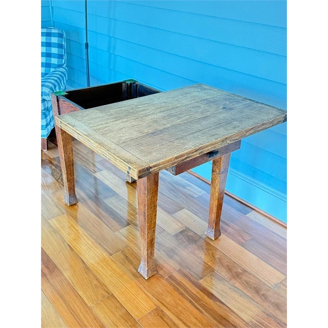 A beautifully aged Arts & Crafts oak game table, dating to approximately 1900–1910, featuring a rare rotating top and...