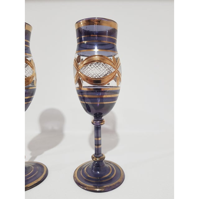 Handmade glass goblets in Venice. Blue shade, decorated with gold leafs. Original vintage item from the 1960s. Dimensions:...