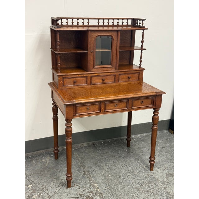 Design Plus Gallery presents an Antique Secretary Desk. This desk is made of quarter-sawn oak with pronounced tiger-oak...