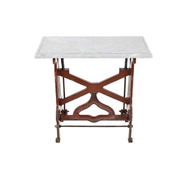 Red industrial table at the marble tray. This piece is designed in the style of the selected designer and/or manufacturer