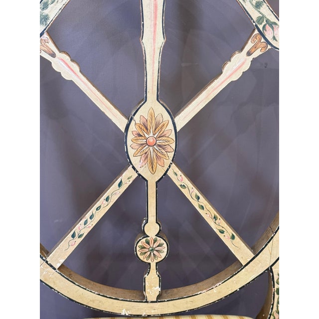 A set of six George III style painted wheel-back side chairs with pierced circular backs formed by radiating splats...