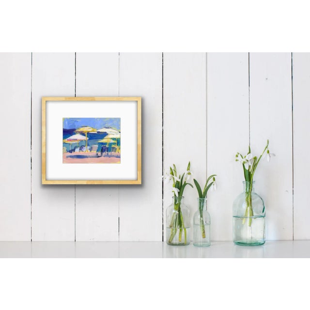 An original print of Michelle Heimann's "Circle of umbrellas." A beachscape showing colorful umbrellas and chairs.