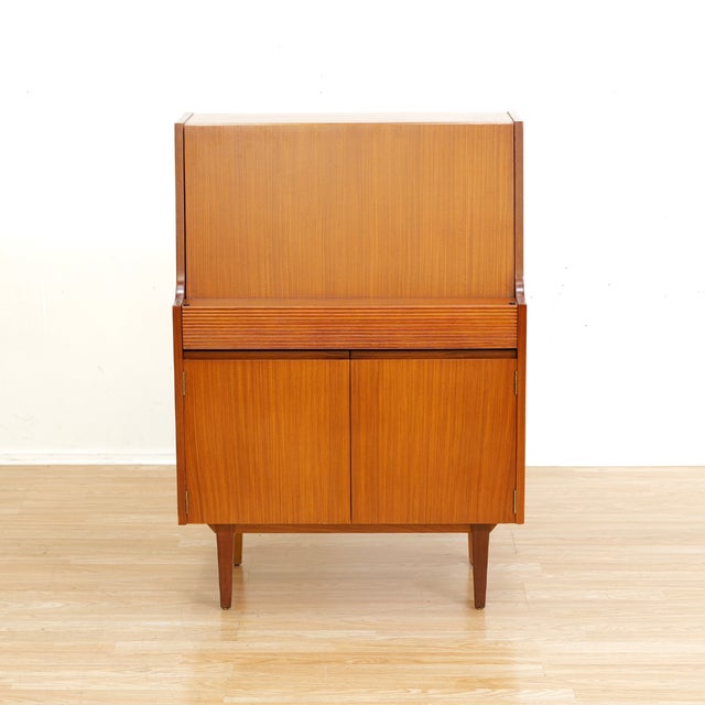 This fabulous mid century desk/cabinet was manufactured in England during 1960s by Elliots of Newbury. A fantastic little...