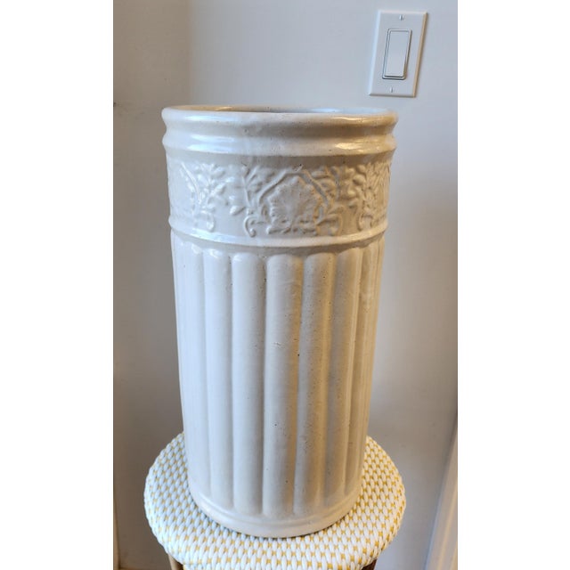 Beautiful white ribbed pottery umbrella/cane stand with a banded vine and leaf pattern at the top, possibly Weller...