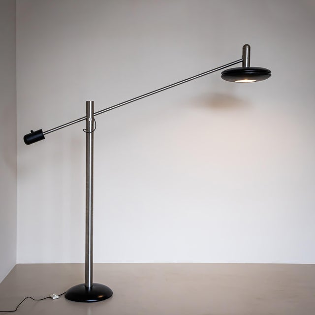 Very large floor lamp with black hemispherical base and smooth stainless-steel stem. The lampshade is mounted on an...