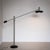 Very large floor lamp with black hemispherical base and smooth stainless-steel stem. The lampshade is mounted on an...