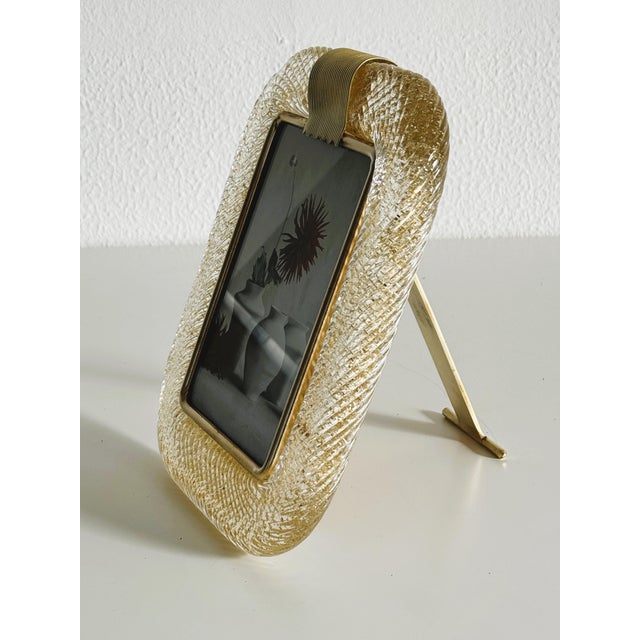 A thick Murano glass picture frame in golden glitter color /transparent color designed and manufactured in Italy, signed...