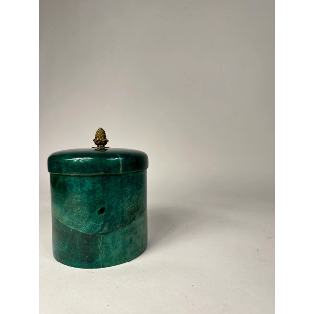Rare turquoise cylindrical goatskin lidded box in the style of Aldo Tura. When it's time to raise the bar, the brass pull...