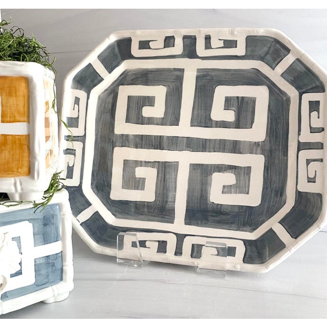 An octagonal platter finished in a solid graphite glaze with a hand-painted Greek key border running the full edge. Made...