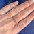 Enter the realm of mystery and optical illusion with this captivating 18 karat white gold Witches Band ring. Crafted...
