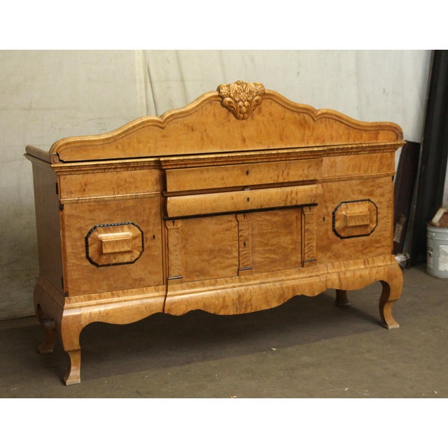 19th century Biedermeier style sideboard with a passthrough design. The book matched burl veneer and detailed carpentry,...
