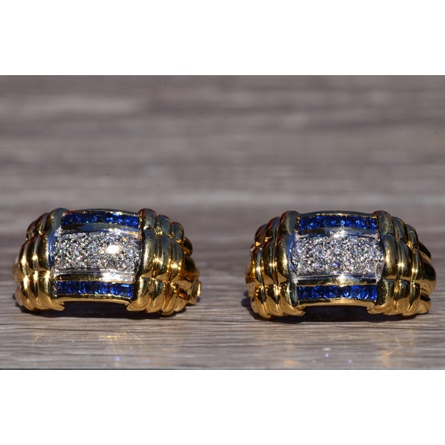 The Glen Canyon: Yellow Gold Sapphire and Diamond Ear Clips. The earrings feature a central section pave set with round...