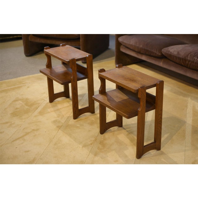 Pair of small oak side tables with a simple and robust design, typical of the 1960s. Each piece features a rectangular top...