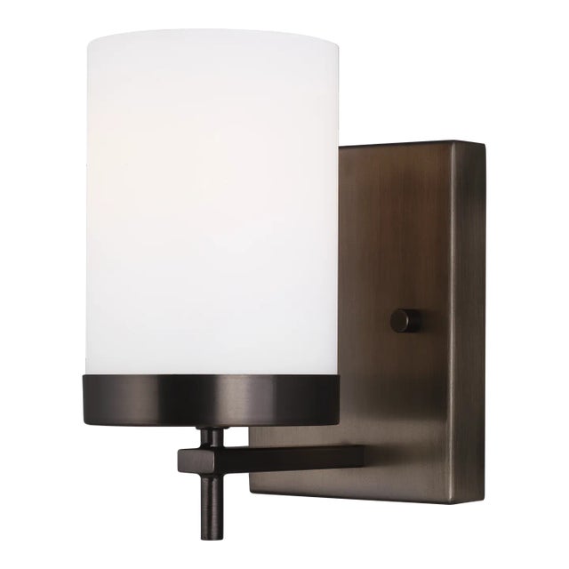 The Zire one light wall sconce in brushed oil rubbed bronze offers shadow-free lighting in your powder room, spa, or...