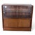 This vintage sliding door bookcase is a classic mid century wooden display cabinet designed to provide stylish and...
