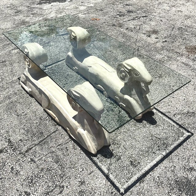 A fabulous vintage Boho coffee table. A chic pair of plaster over wood ram’s head design. Heavy glass top. Acquired from a...