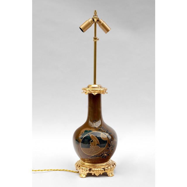 - Pair of baluster shape brown and blue porcelain lamps - Decoration of Japanese style figures in a cartouche frame - With...