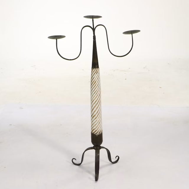 A captivating pair of Spanish Baroque-style floor candlesticks that are highly sculptural as well as functional. Each...