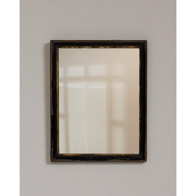 Carved ebonized wall mirror in Deep Ebony Black. Finished in deep ebony black, this carved ebonized wall mirror is...