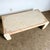 Postmodern beige and pink tessellated stone rectangular coffee table featuring a sleek design with brass inlay. This...