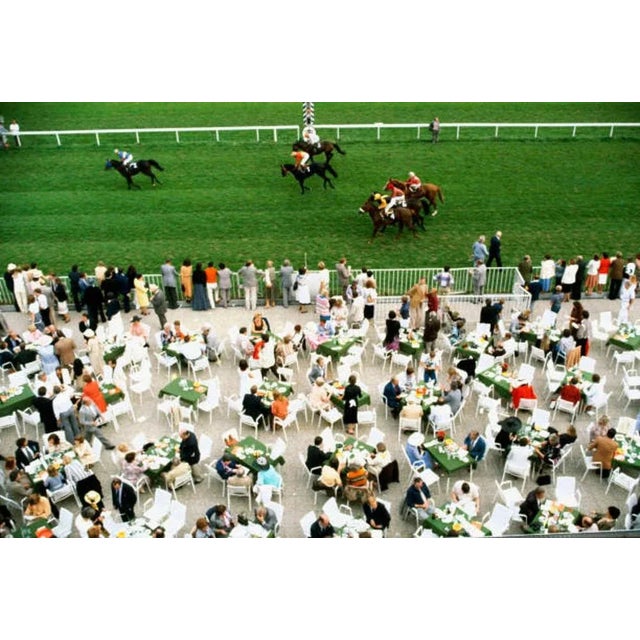 Racing At Baden Baden 1978 by Slim Aarons Slim Aarons Limited Estate Edition Spectators dine in the open air as the horses...