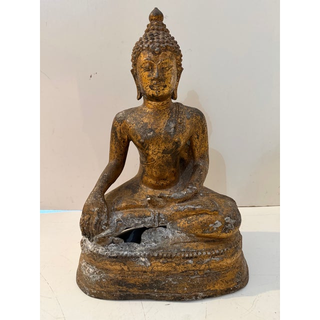 Vintage Thai bronze Buddha statue featuring a serene expression and classic seated form. This sculptural piece showcases...