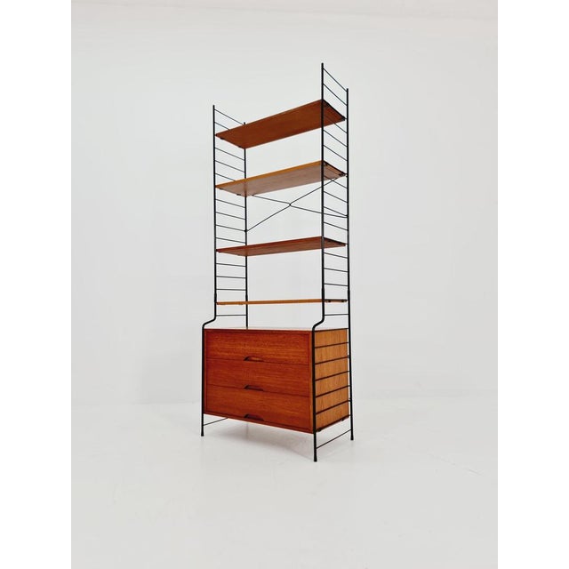 Freestanding String shelving system, bookcase with cabinet, teak, by WHB Germany, 1950s. The bookcase system is in good...