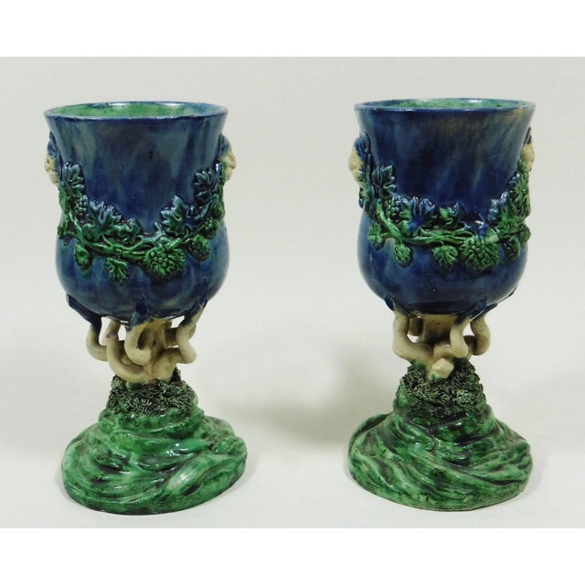 Pair of 19th century Palissy chalices with lions heads and grapes garlands, the feets are stylized seaweeds in a...