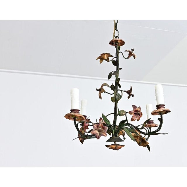 French vintage tôle chandelier, circa 1950, the metal carefully forged and wrought into romantic vines of blooming flowers...