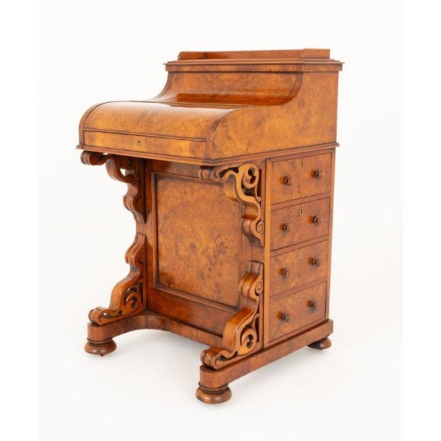 Burr walnut Victorian pop up Davenport desk. This Davenport stands upon turned feet with carved and shaped supports. Circa...