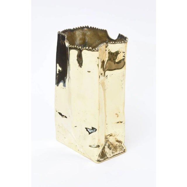This amazing hallmarked French signed limited edition bronze/brass paper bag sculpture is signed Use Honure 90 26/170. It...