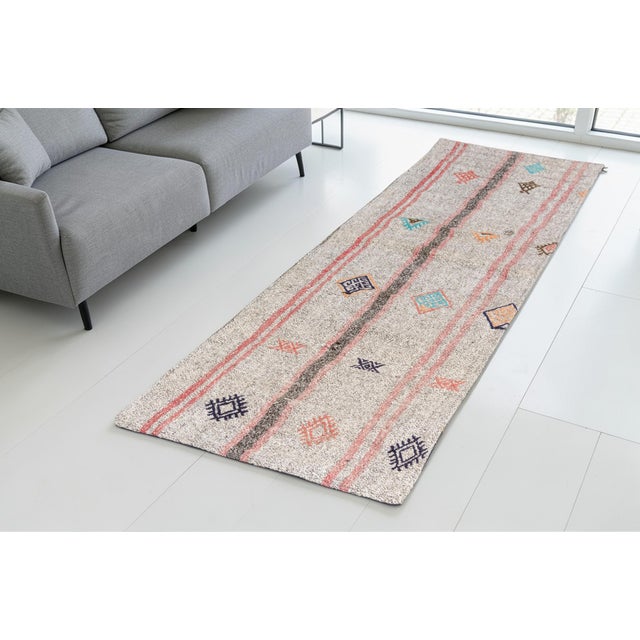 This is a vintage Turkish Oushak rug from the Mid 20th Century. The piece was hand-knotted.