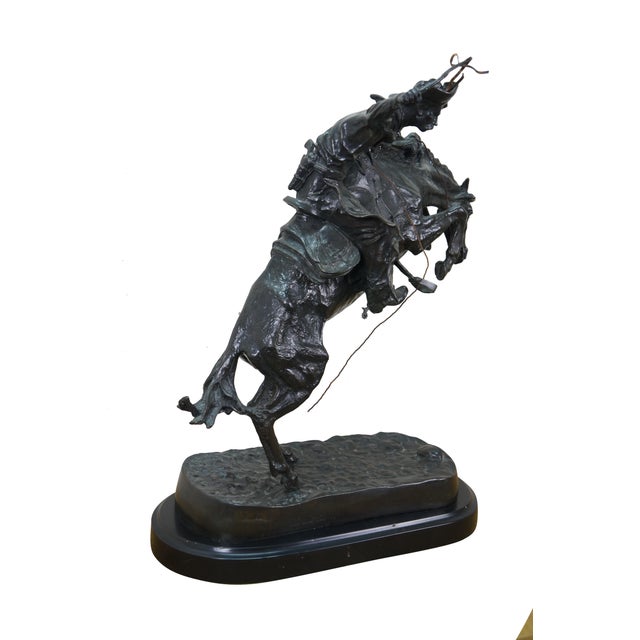 Mid century Frederic Remington bronze sculpture titled "The Bronco Buster," produced by Roman Bronze Works, New York....