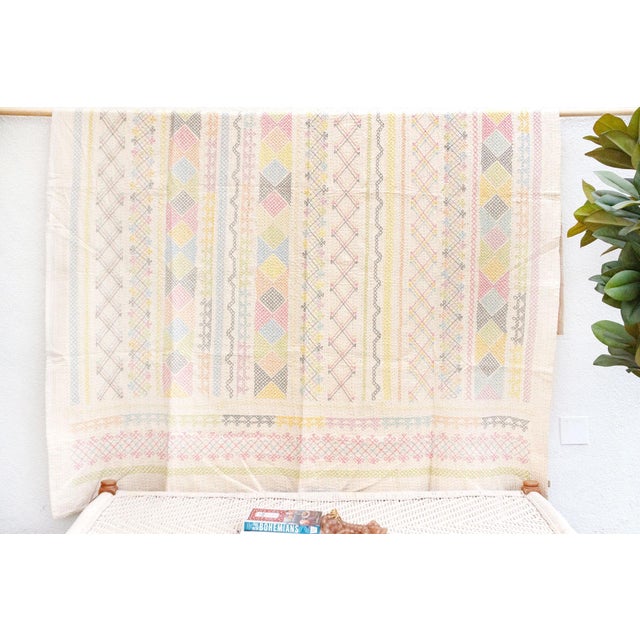 Discover the timeless artistry of this pastel geometric hand-stitched cotton Kantha bedcover. This piece offers a touch of...