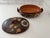 This is a vintage Mexican Tlaquepaque redware lidded casserole dish featuring a hand-painted floral folk art motif. These...