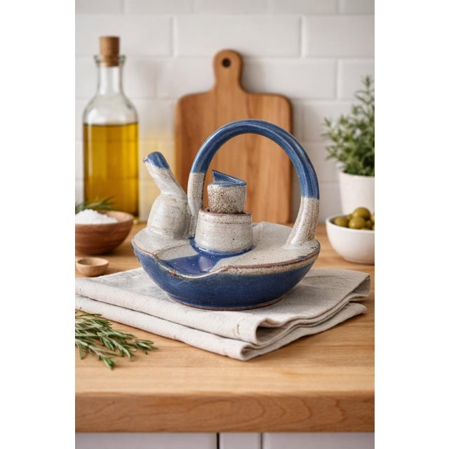 A distinctive mid-century studio art pottery pouring vessel, combining functional design with sculptural form. This...