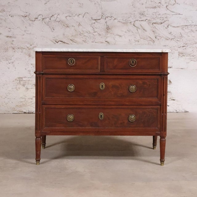 This 19th Century Louis XVI Chest with White Marble Top is a refined antique that captures the timeless elegance and...