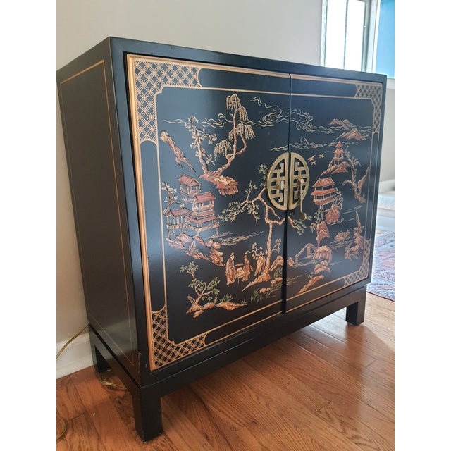 Beautiful black lacquered with unique door hardware that latches. One interior shelf that is fixed at 13" high from the...