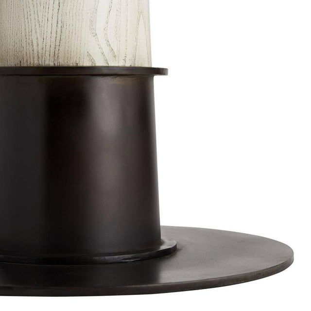 A larger version of our Kamile Side Table, this pub-style stand has mastered the elements of mixed materials. A smoke gray...