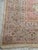 oversized vintage Persian-style rug featuring a soft ivory field, dusty rose accents, and powder blue detailing. This...
