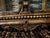 Up for sale is an absolute masterpiece of old-world European craftsmanship: a grand, heavy-framed antique tabletop vitrine...