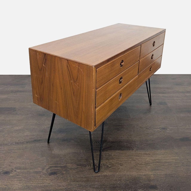 This dresser features a classic mid-century modern design with six spacious drawers for storage. The warm wood finish and...