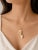 This modern 14K yellow gold necklace features a white agate key pendant slide , offering a stylish and symbolic design. A...